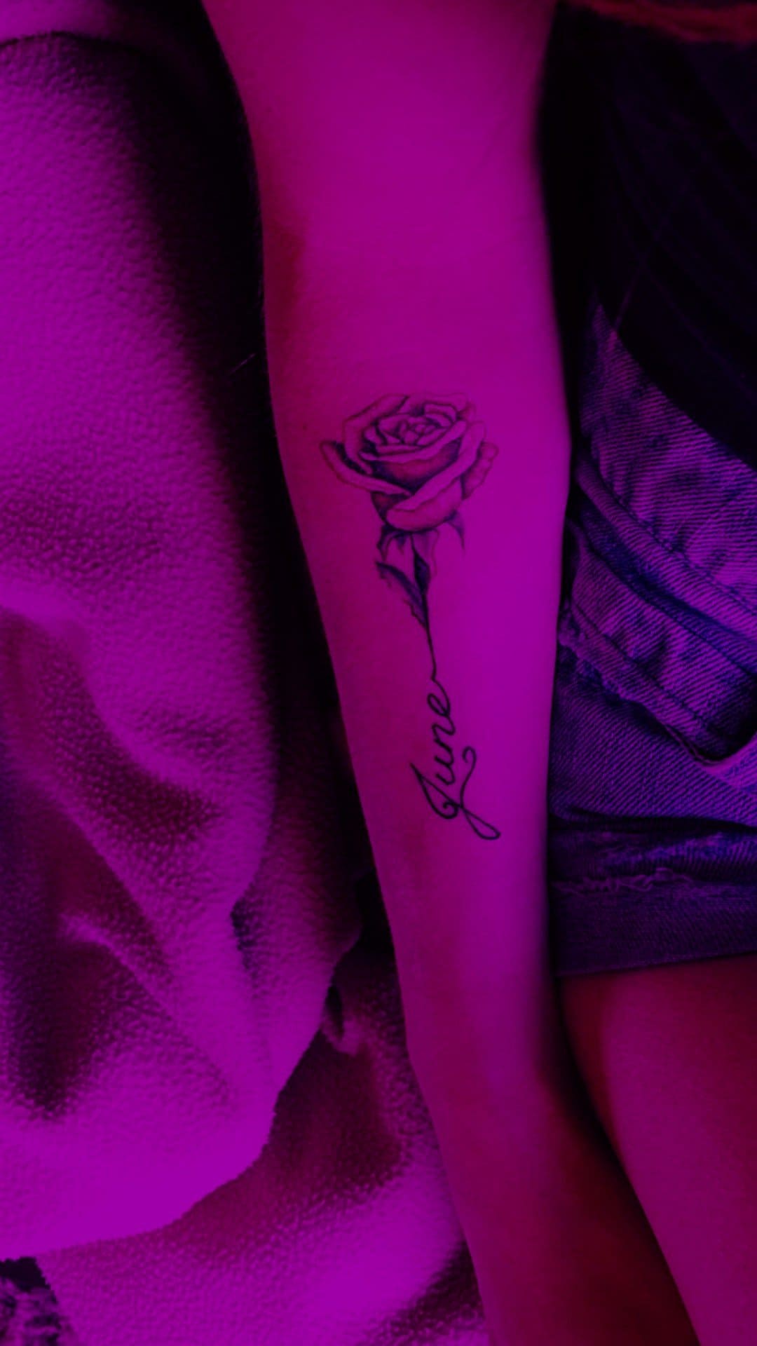 Lettering tattoo name June and rose on the arm.